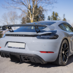Back view Porsche Cayman GT4 on Lake Constance