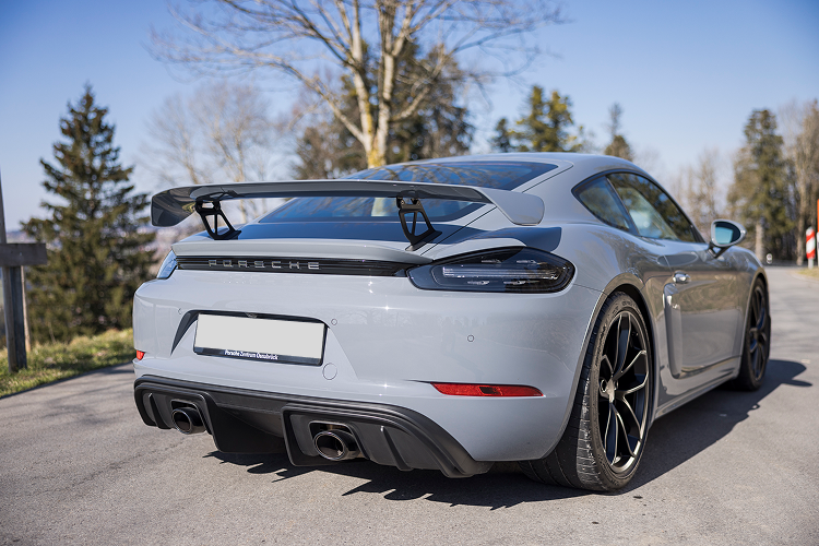 Back view Porsche Cayman GT4 on Lake Constance