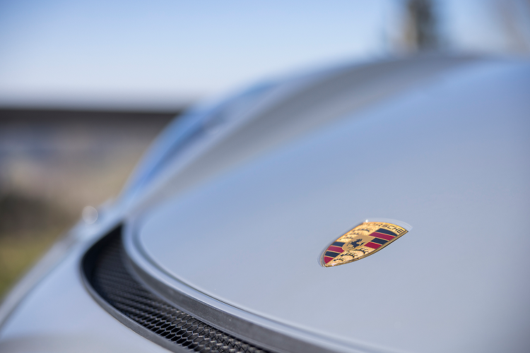 Front logo Porsche Cayman GT4 on Lake Constance