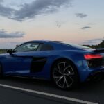 Audi R8 sports car in a sleek silver finish, showcasing its aerodynamic design and powerful performance