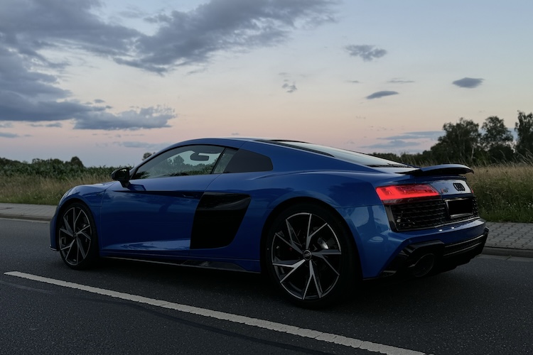 Audi R8 sports car in a sleek silver finish, showcasing its aerodynamic design and powerful performance