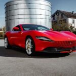 Ferrari Roma in red parked on a scenic road, showcasing its sleek design and powerful features
