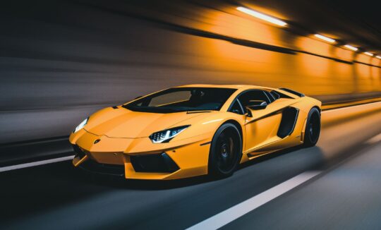 yellow Lamborghini aventador speeding in a tunnel